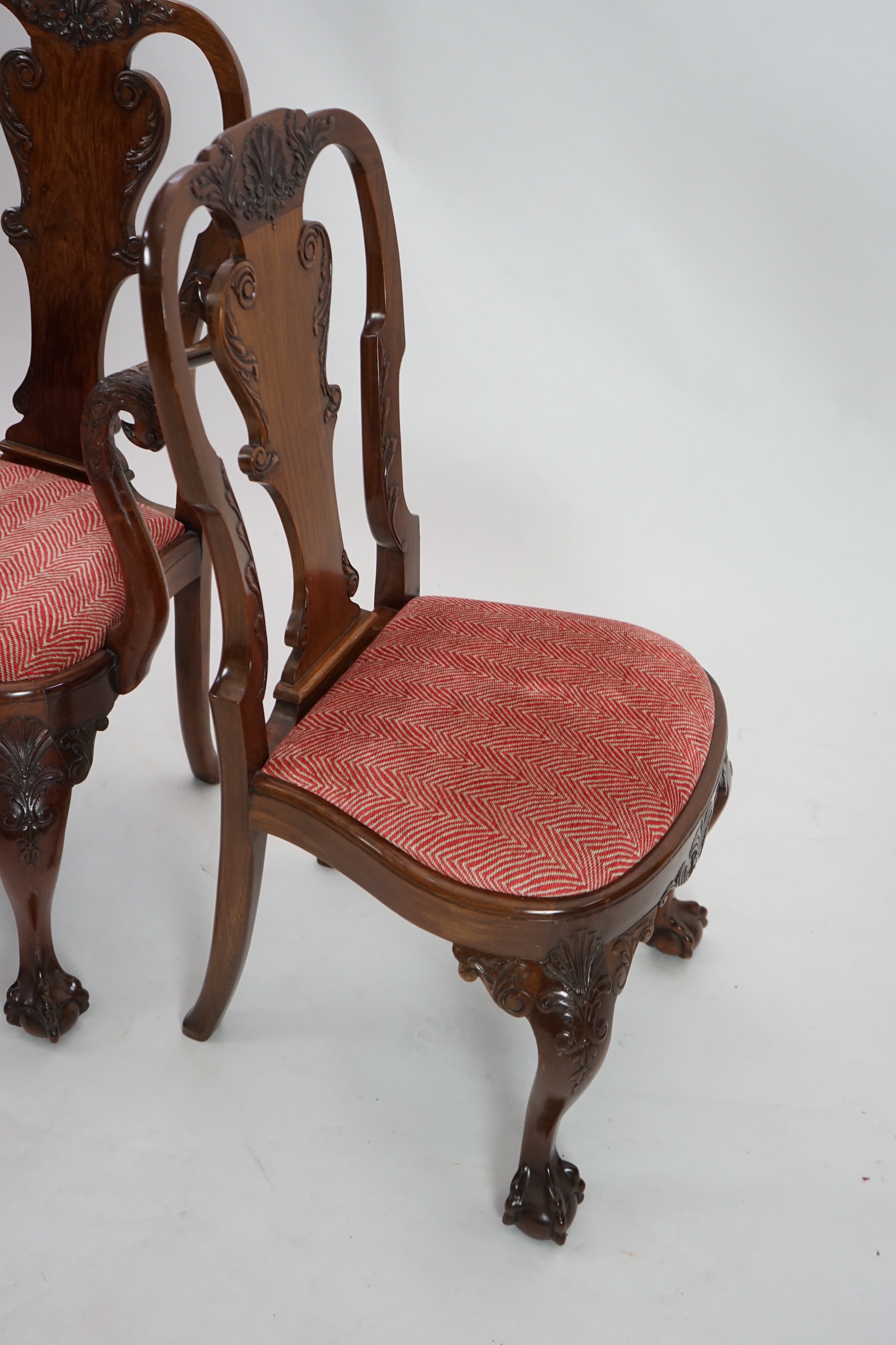 A set of twelve Queen Anne revival walnut dining chairs, including two carvers